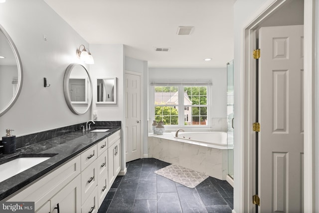 full bathroom with a bath, visible vents, a sink, and double vanity
