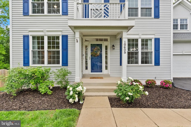 entrance to property with a balcony and an attached garage