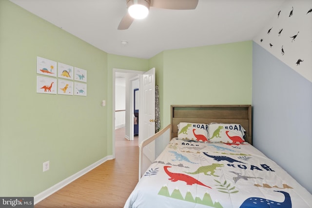 bedroom with baseboards, wood finished floors, and a ceiling fan