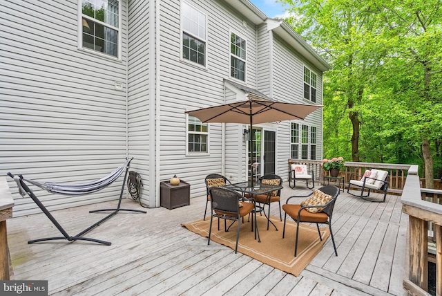 wooden terrace with outdoor dining space