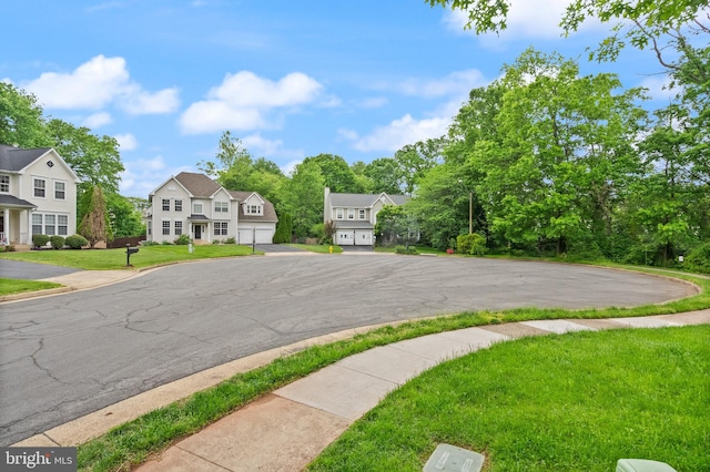 view of road featuring a residential view, curbs, and sidewalks