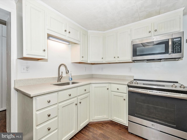 12836 Hessong Bridge Rd, Thurmont, MD 21788 - kitchen with white cabinets, appliances with stainless steel finishes, a sink, light countertops, and dark wood finished floors