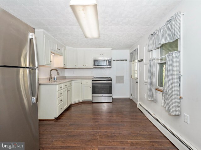 12836 Hessong Bridge Rd, Thurmont, MD 21788 - kitchen featuring appliances with stainless steel finishes, a sink, baseboard heating, light countertops, and dark wood-type flooring