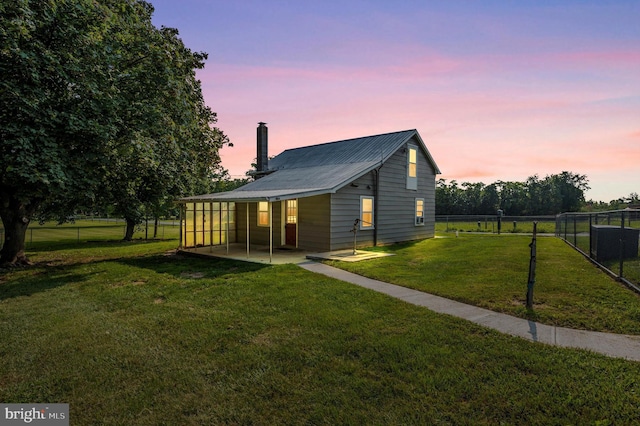 12836 Hessong Bridge Rd, Thurmont, MD 21788 - exterior space with fence, a chimney, a patio area, metal roof, and a lawn