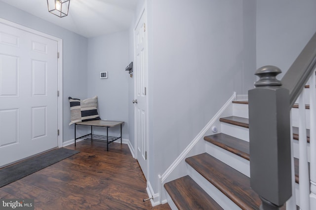 entryway featuring stairs, wood finished floors, and baseboards