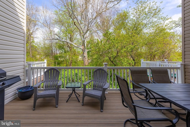 wooden deck featuring outdoor dining space