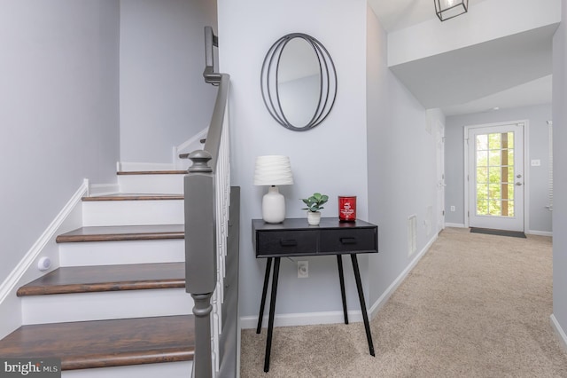 stairs featuring carpet, visible vents, and baseboards