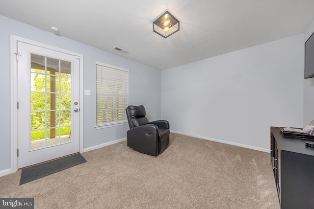 unfurnished room with carpet, visible vents, and baseboards
