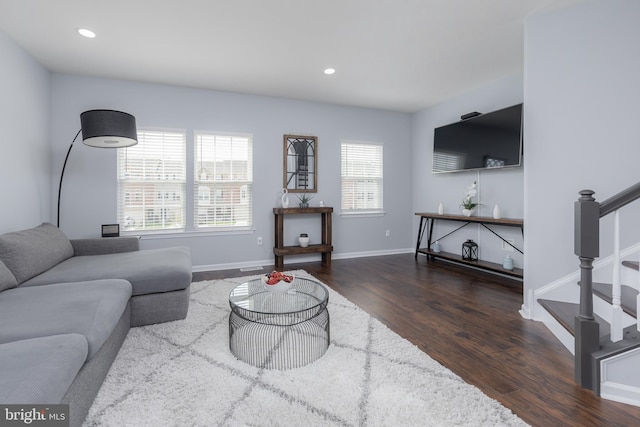 living room with baseboards, wood finished floors, recessed lighting, and stairs