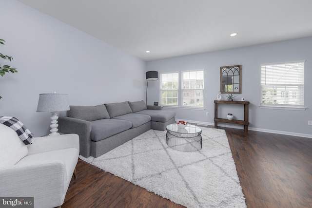living room featuring baseboards, recessed lighting, and dark wood-type flooring