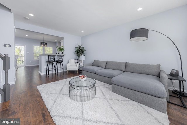 living area with recessed lighting, baseboards, and dark wood-style flooring