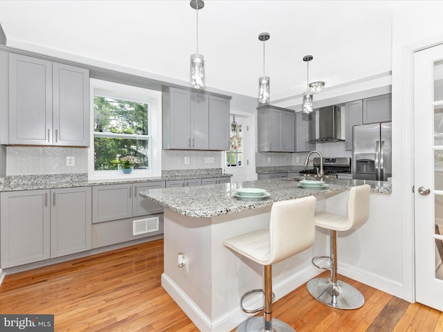 507 Kerwin Ct, Silver Spring, MD 20901 - kitchen featuring wall chimney range hood, appliances with stainless steel finishes, gray cabinets, and decorative backsplash