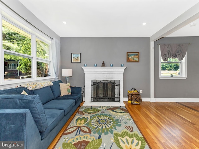 507 Kerwin Ct, Silver Spring, MD 20901 - living room featuring healthy amount of natural light, a brick fireplace, wood finished floors, baseboards, and recessed lighting