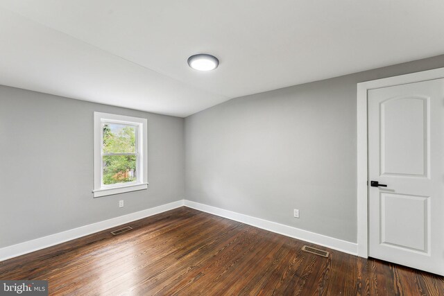 3104 Douglas St NE, Washington, DC 20018 - unfurnished room with baseboards, dark wood-style floors, and vaulted ceiling