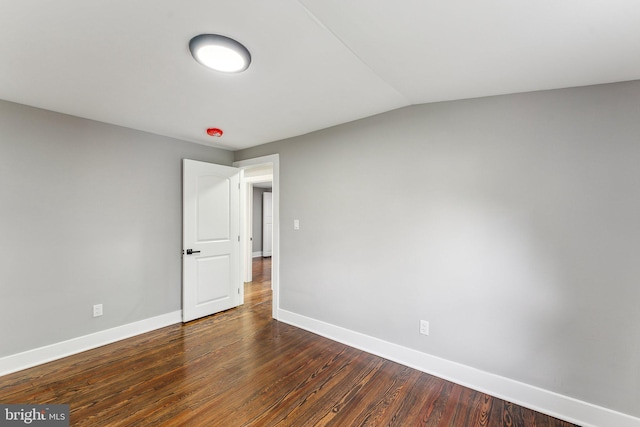 3104 Douglas St NE, Washington, DC 20018 - empty room with baseboards, dark wood-style flooring, and vaulted ceiling