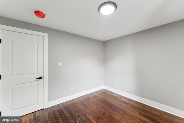 3104 Douglas St NE, Washington, DC 20018 - unfurnished room featuring baseboards and dark wood-style flooring