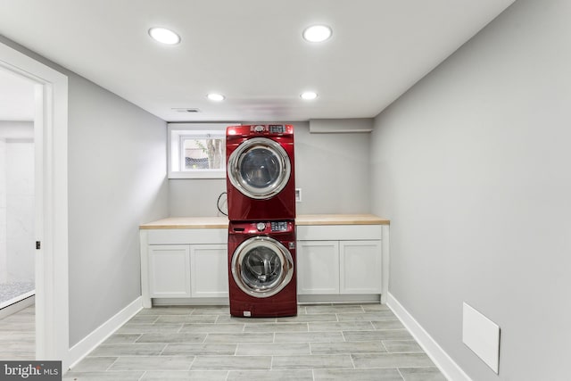 3104 Douglas St NE, Washington, DC 20018 - washroom featuring stacked washer / drying machine, cabinet space, recessed lighting, baseboards, and light wood-style floors