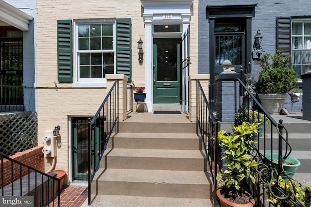 property entrance with brick siding