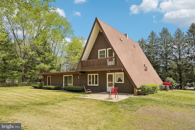 back of house featuring a patio and a lawn