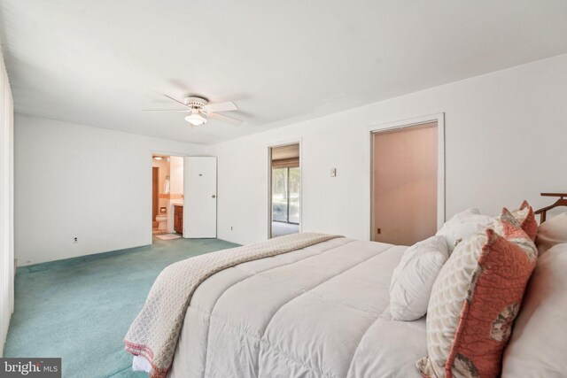 carpeted bedroom with ensuite bathroom and ceiling fan