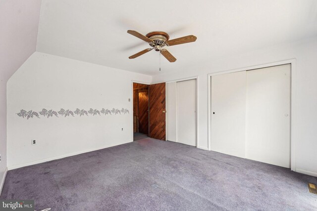 unfurnished bedroom featuring multiple closets, carpet, and a ceiling fan