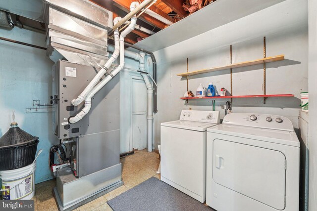 laundry room with washer and dryer, laundry area, and light floors
