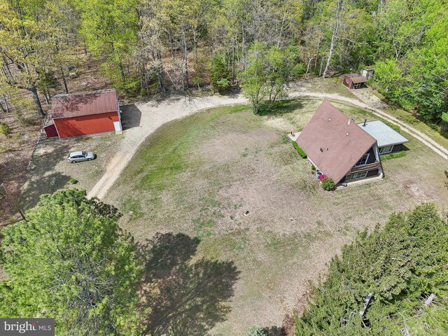 drone / aerial view with a wooded view