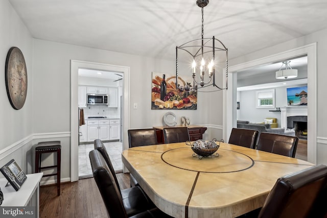 40 Treaty Elm Ln, Haddonfield, NJ 08033 - dining area with a fireplace, wood finished floors, and a notable chandelier