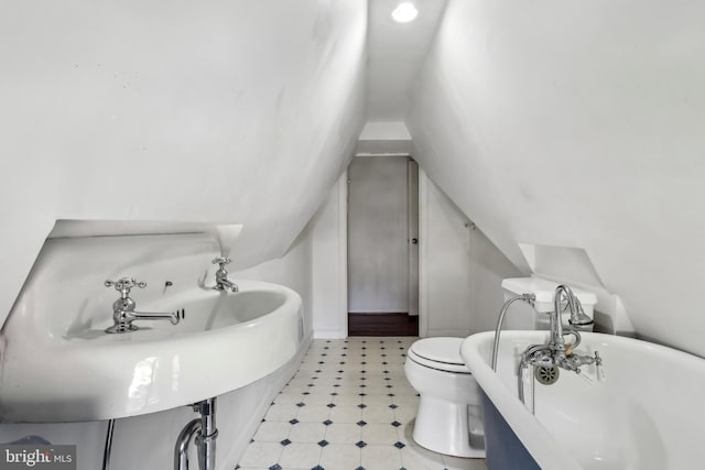 40 Treaty Elm Ln, Haddonfield, NJ 08033 - bathroom with tile patterned floors, a freestanding bath, toilet, a sink, and lofted ceiling