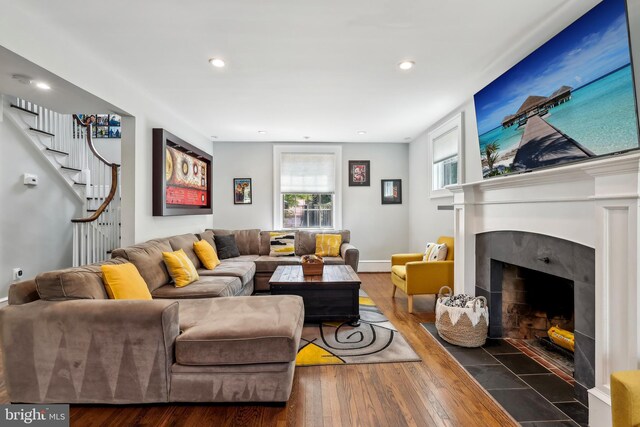 40 Treaty Elm Ln, Haddonfield, NJ 08033 - living room with recessed lighting, stairs, a tiled fireplace, and wood finished floors