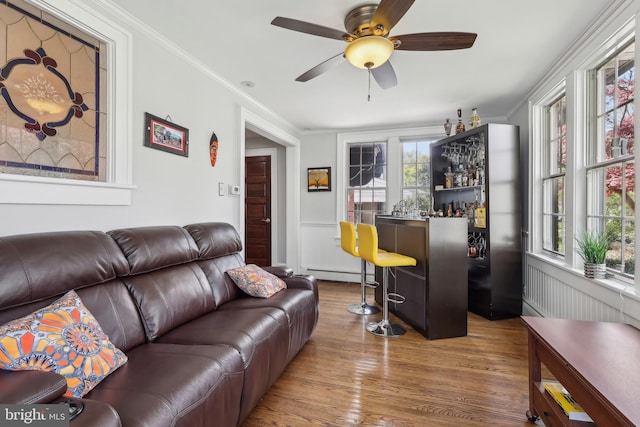 40 Treaty Elm Ln, Haddonfield, NJ 08033 - living area with a dry bar, a baseboard radiator, wood finished floors, and a healthy amount of sunlight