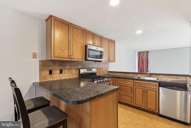 18 University Mews, Philadelphia, PA 19104 - kitchen featuring a sink, brown cabinets, stainless steel appliances, and a peninsula