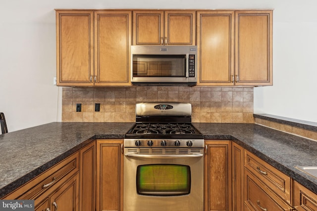 18 University Mews, Philadelphia, PA 19104 - kitchen with brown cabinetry, decorative backsplash, appliances with stainless steel finishes, and dark countertops