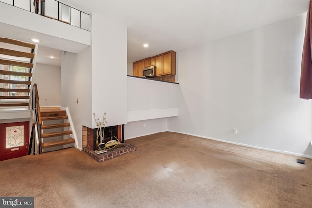 18 University Mews, Philadelphia, PA 19104 - unfurnished living room with a fireplace, stairs, baseboards, carpet, and recessed lighting