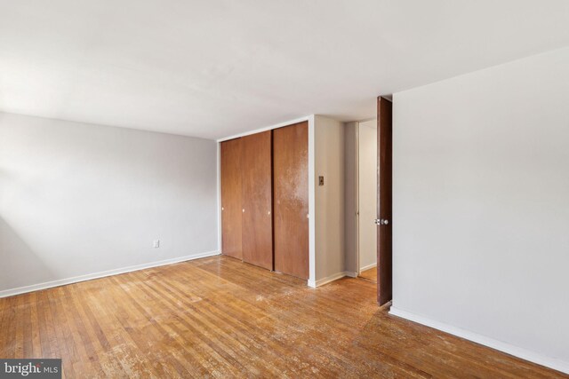 18 University Mews, Philadelphia, PA 19104 - unfurnished bedroom featuring baseboards, a closet, and wood finished floors