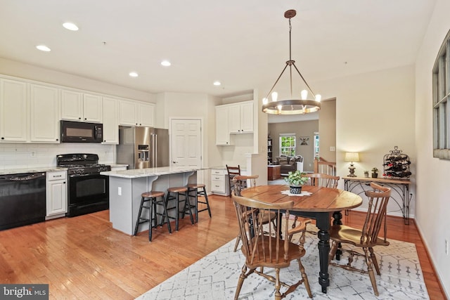 7601 Willow Bottom Rd, Sykesville, MD 21784 - dining space with a notable chandelier, light wood finished floors, and recessed lighting