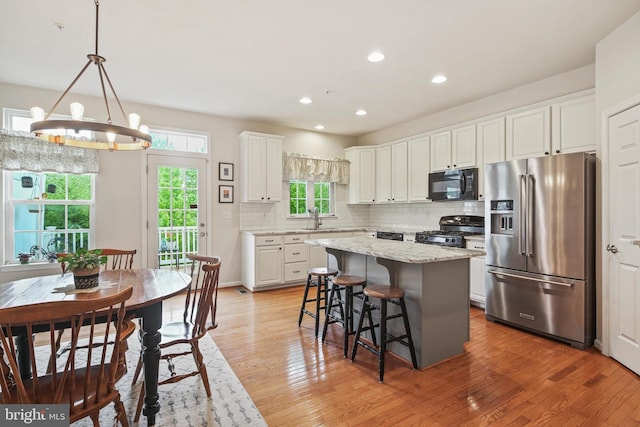 7601 Willow Bottom Rd, Sykesville, MD 21784 - kitchen with high quality fridge, a notable chandelier, a center island, gas stove, and black microwave