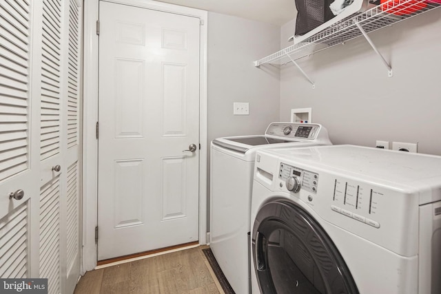 7601 Willow Bottom Rd, Sykesville, MD 21784 - washroom with separate washer and dryer, laundry area, and light wood-type flooring