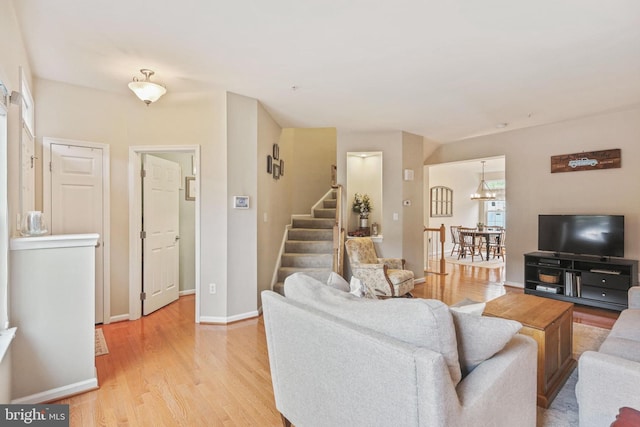 7601 Willow Bottom Rd, Sykesville, MD 21784 - living room featuring baseboards, stairway, and light wood-type flooring