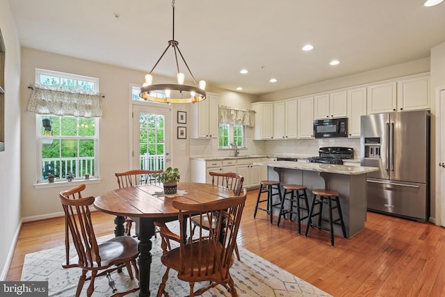 7601 Willow Bottom Rd, Sykesville, MD 21784 - dining space with baseboards, light wood-style floors, an inviting chandelier, and recessed lighting