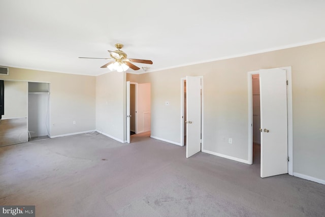 unfurnished bedroom with baseboards, ornamental molding, a ceiling fan, and carpet