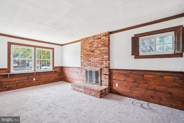 107 Bonnie View Rd, Glen Burnie, MD 21060 - unfurnished living room with wood walls, a wainscoted wall, a fireplace, carpet flooring, and crown molding