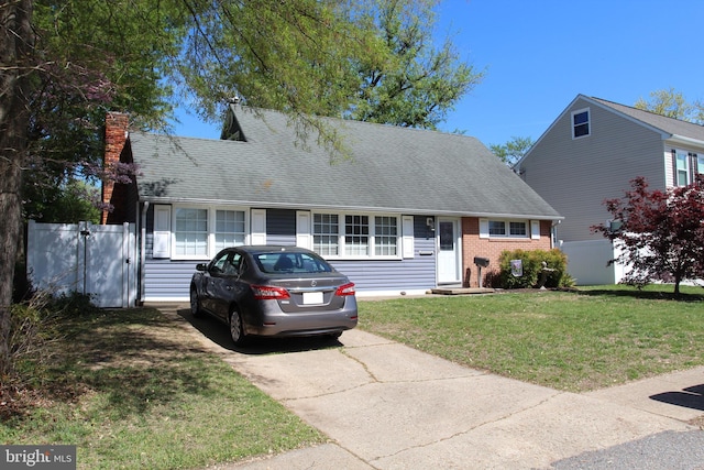 107 Bonnie View Rd, Glen Burnie, MD 21060 - cape cod-style house featuring a chimney, brick siding, a shingled roof, and concrete driveway