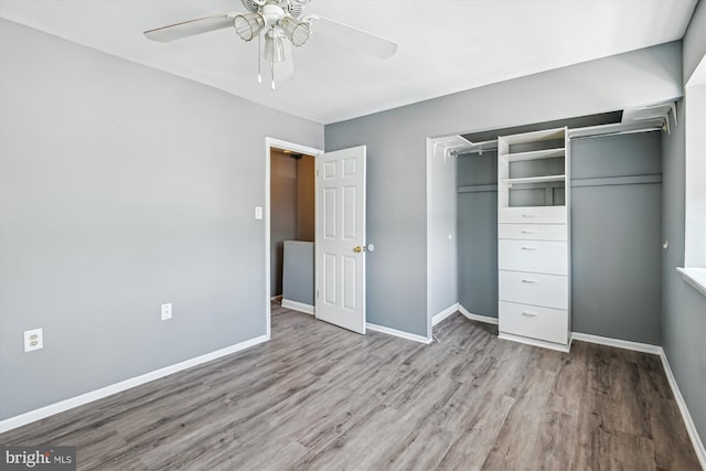 unfurnished bedroom with a closet, baseboards, ceiling fan, and wood finished floors