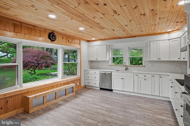 kitchen featuring stainless steel dishwasher, a sink, white cabinetry, light countertops, and recessed lighting