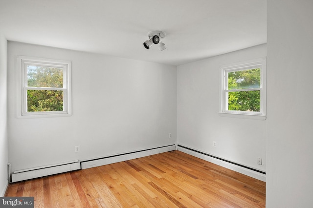 empty room with wood finished floors and baseboards