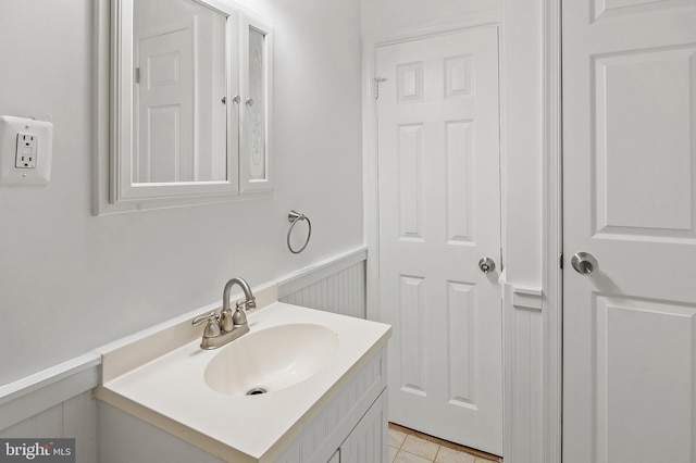 bathroom featuring wainscoting, vanity, and tile patterned flooring