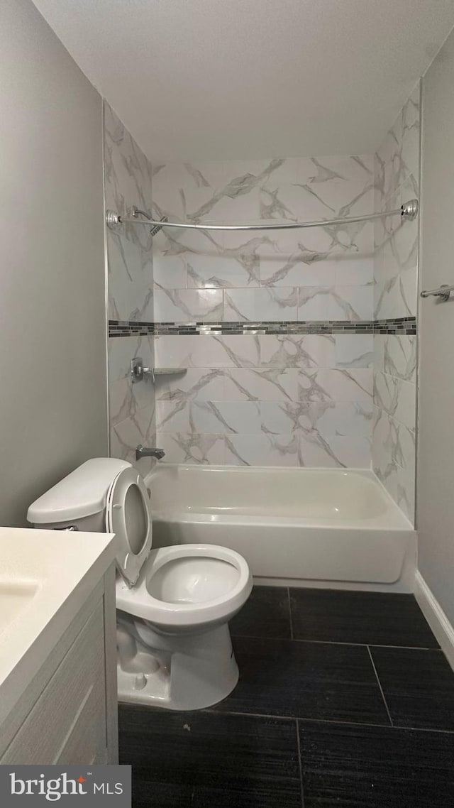 bathroom with toilet, shower / bathing tub combination, and vanity