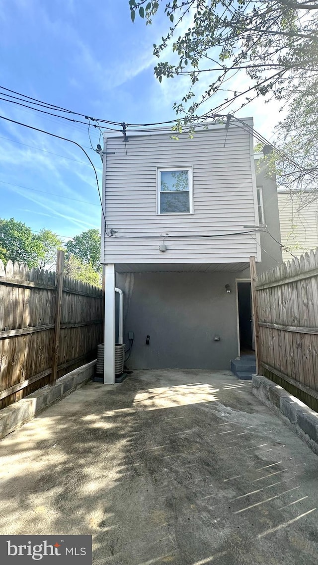 rear view of house featuring fence and a patio