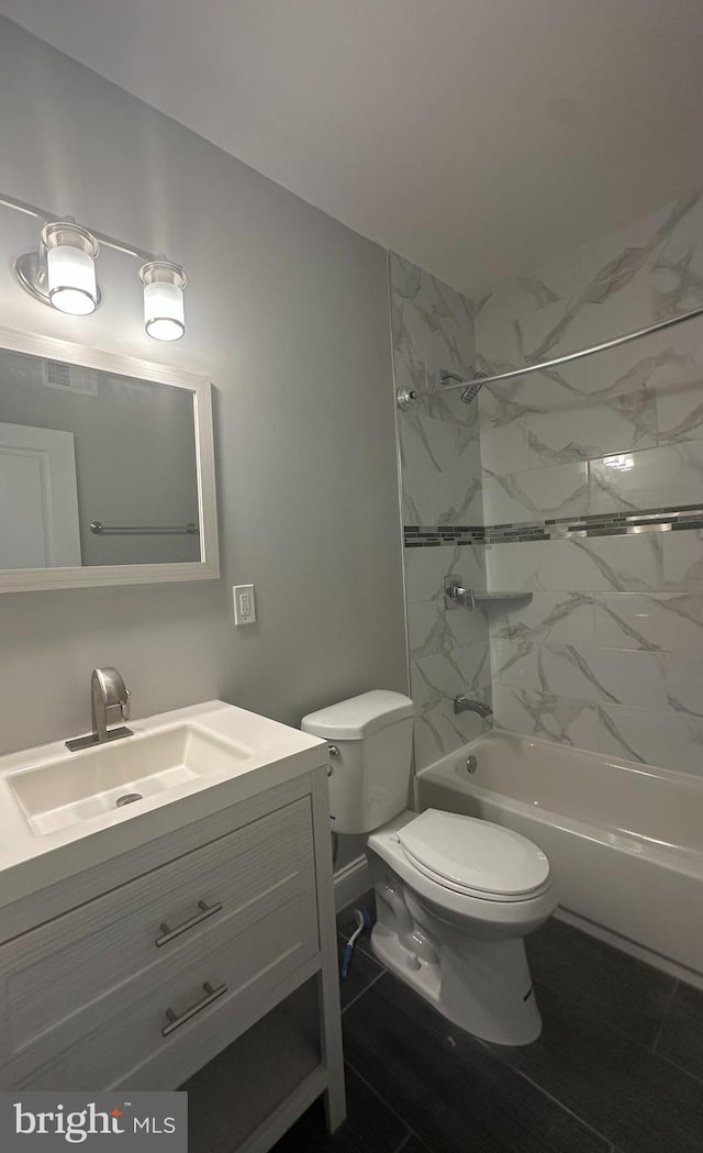 bathroom with vanity, washtub / shower combination, visible vents, and toilet